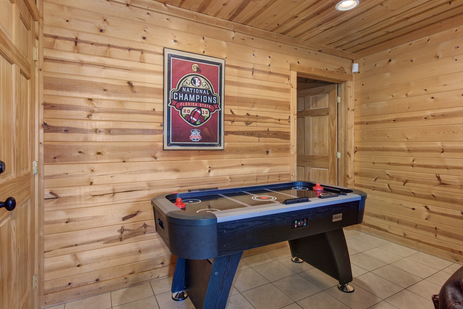 The game room retreat features a pool table, air hockey, sleeper sofa, & TV