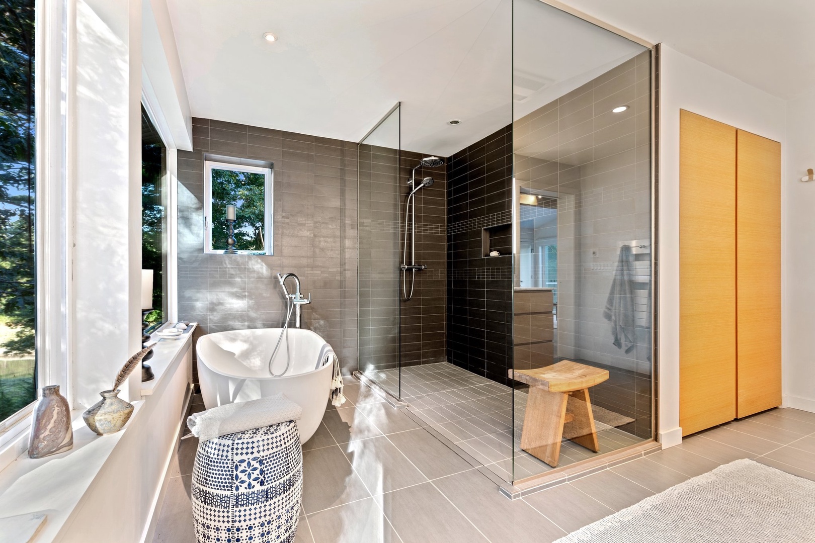 Indulge in a modern bathroom with a walk-in shower, soak tub, and stunning views