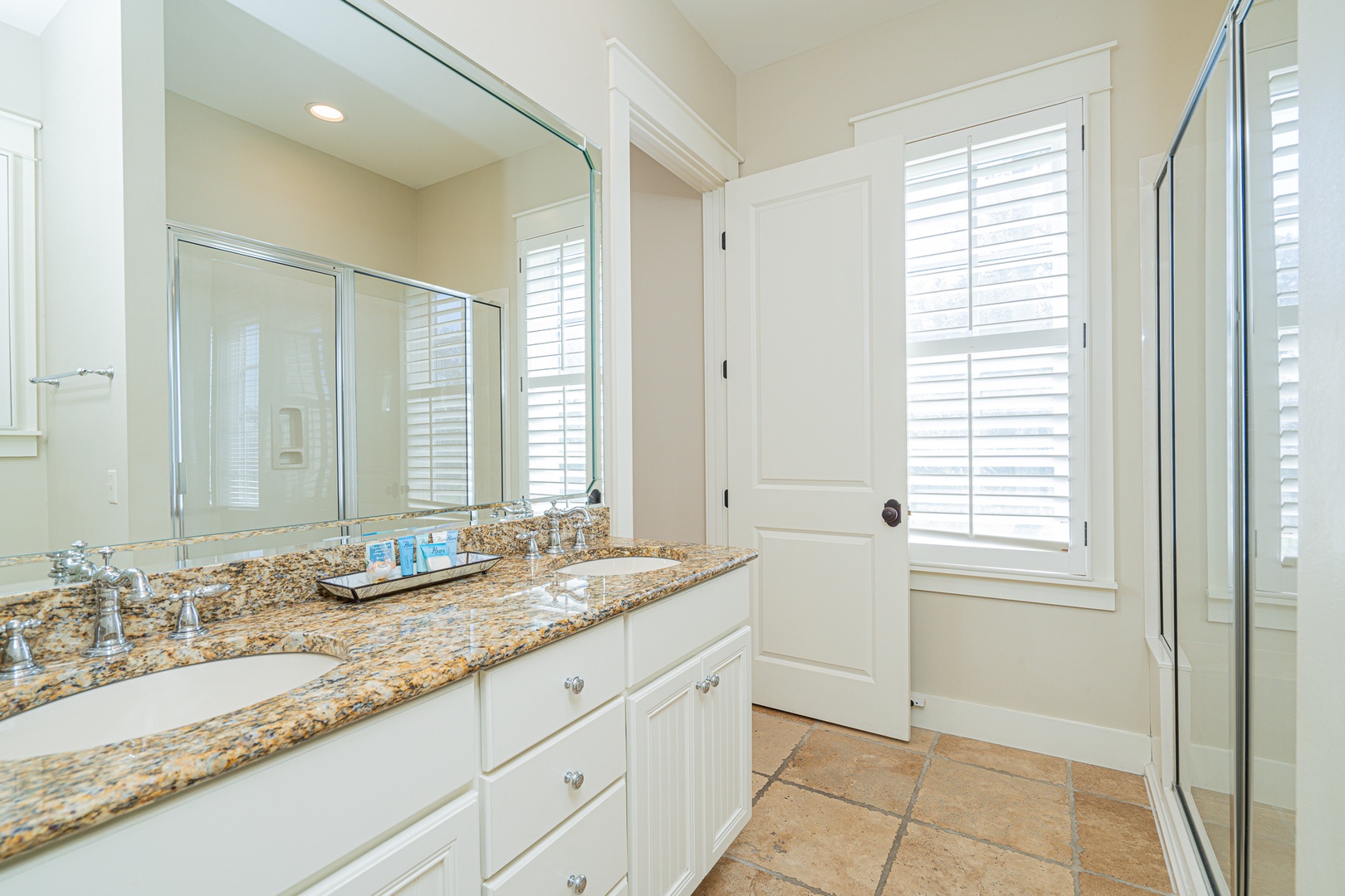 The king ensuite showcases a double vanity & glass shower