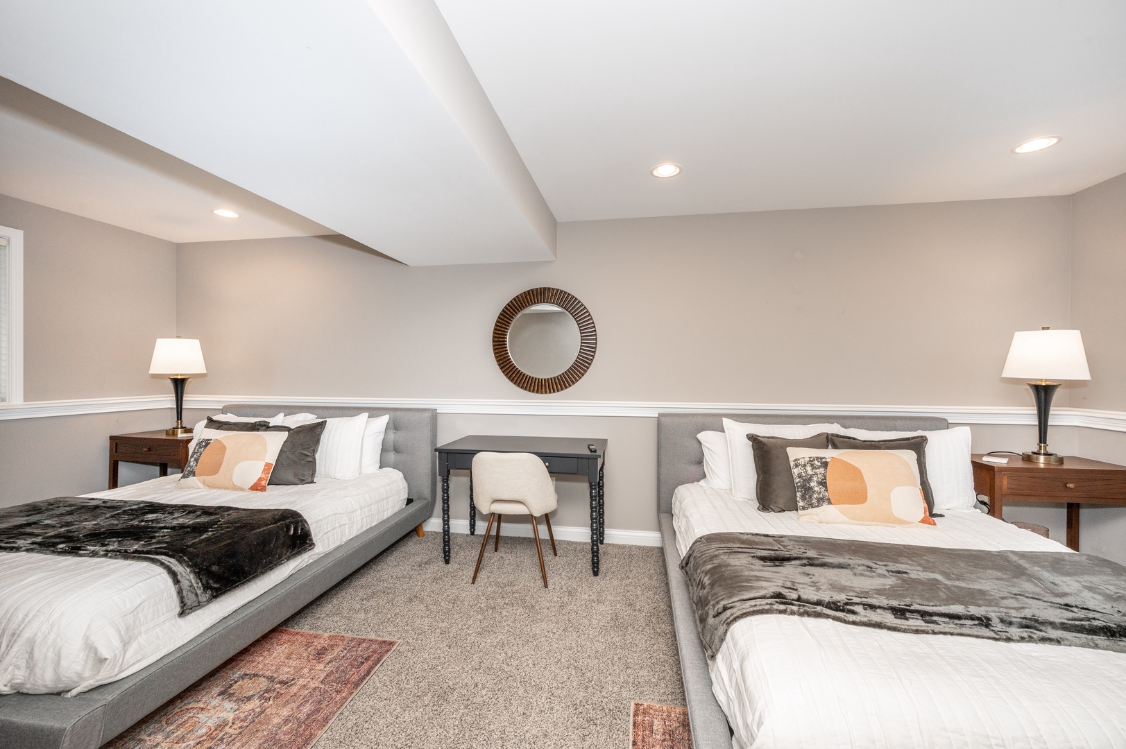 The lower level bedroom offers a pair of queen beds & half ensuite bath