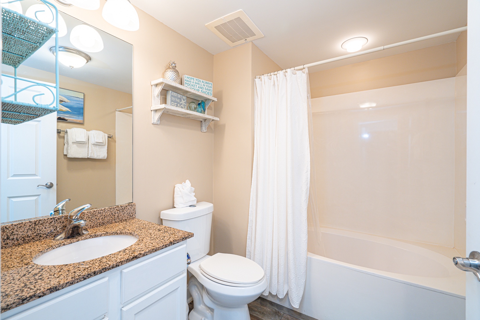 The full shared bathroom contains a single vanity & shower/tub combo