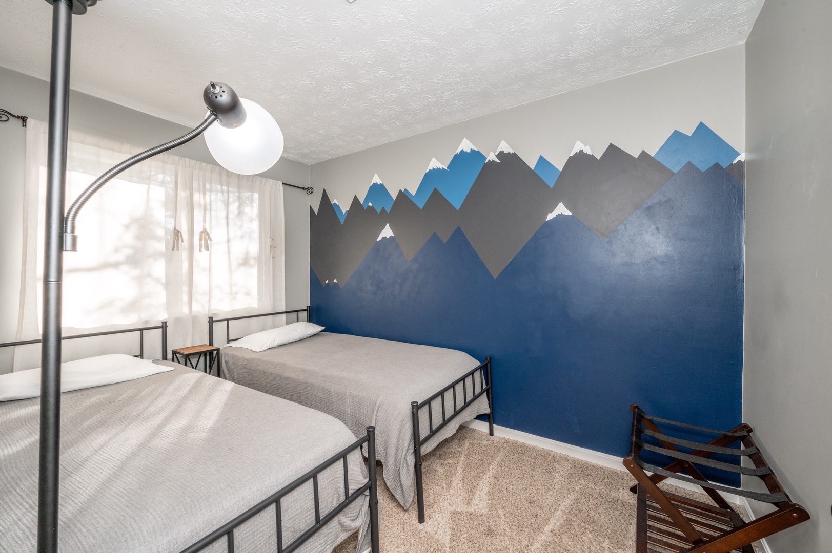 The second upper-level bedroom offers a pair of cozy twin beds