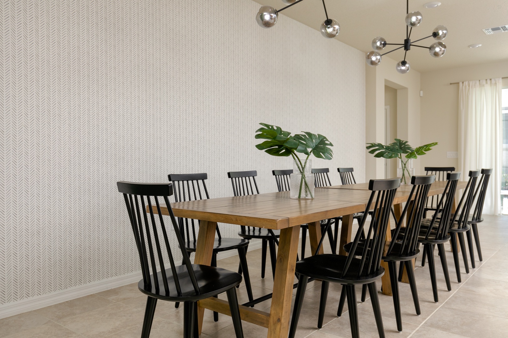 Gather for meals together at the chic dining table, offering seating for 12