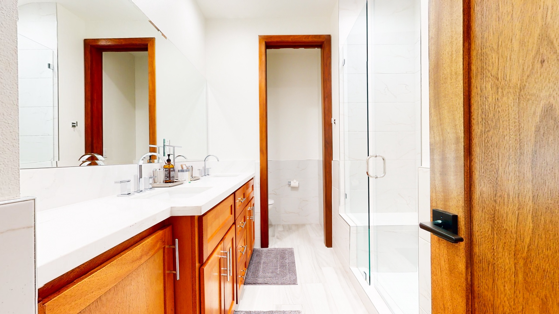 The 3rd floor hall bath offers a sprawling double vanity and gorgeous glass shower