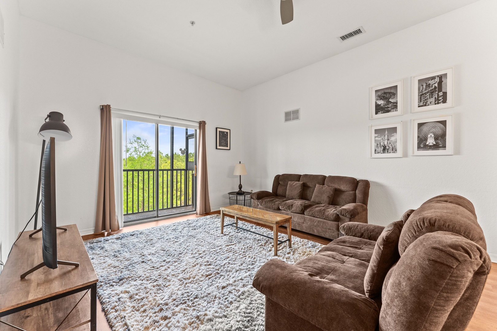 Living area with high ceilings, ample seating, and Smart TV
