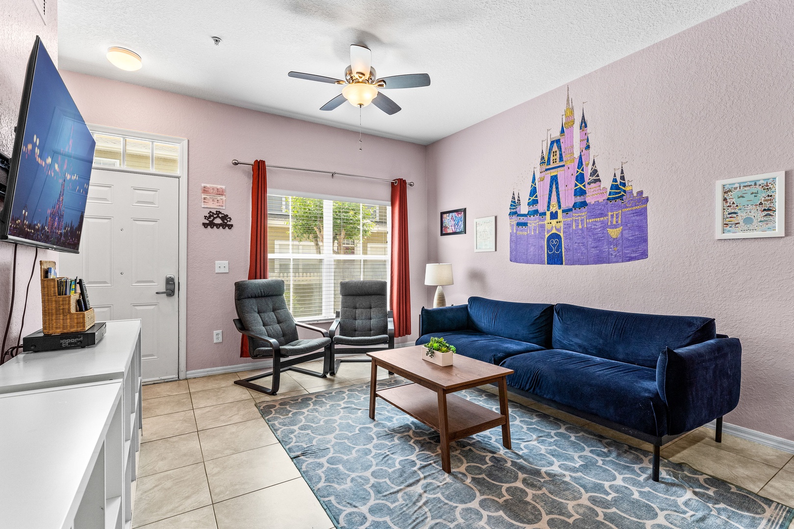 Cozy and spacious living area with, ceiling fan & smart TV