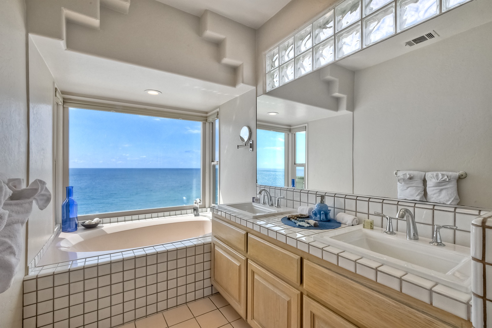 The king ensuite offers a double vanity, glass shower, & soaking tub