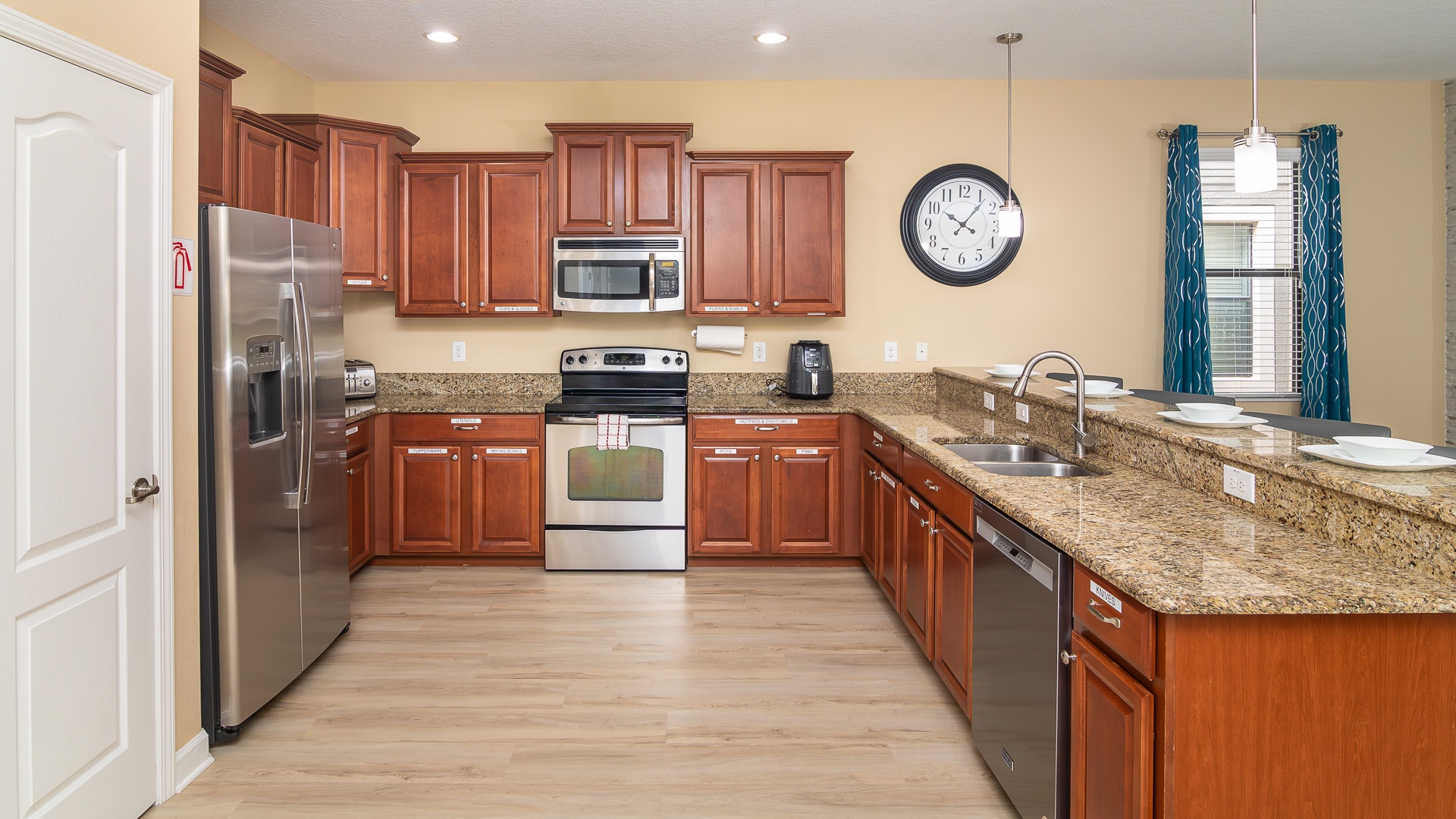 The chic, open kitchen offers ample space & all the comforts of home