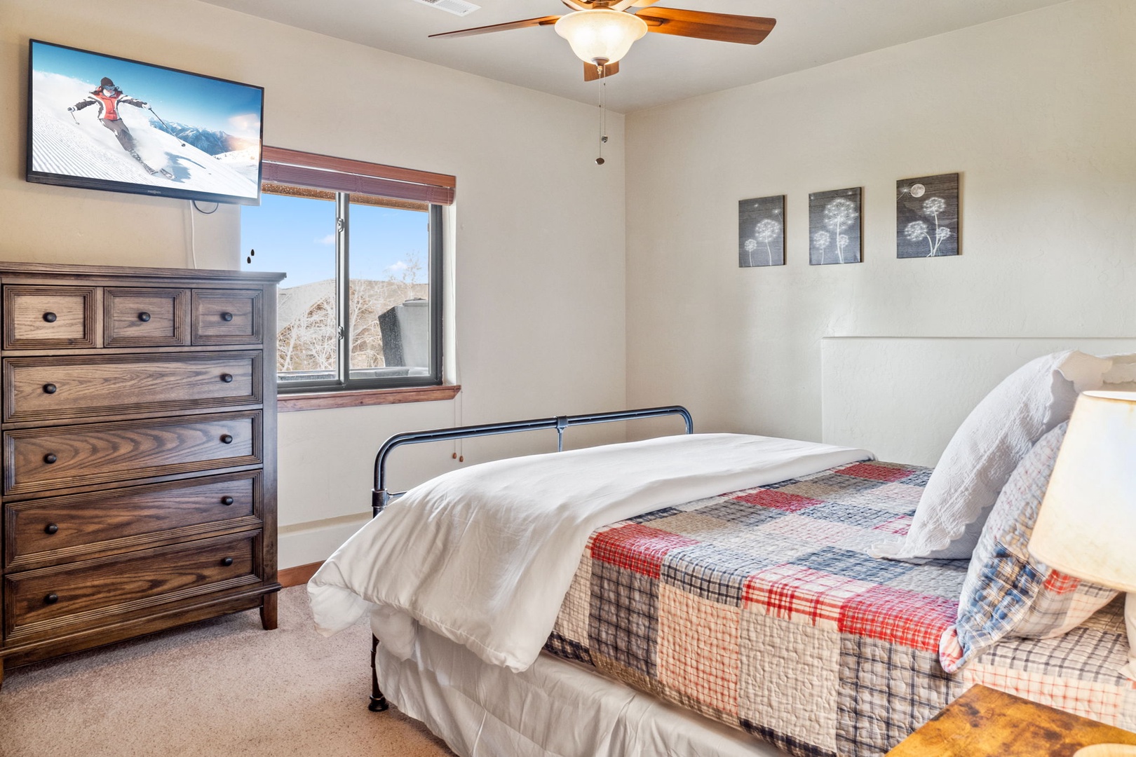 The final bedroom showcases a comfy queen bed & smart TV