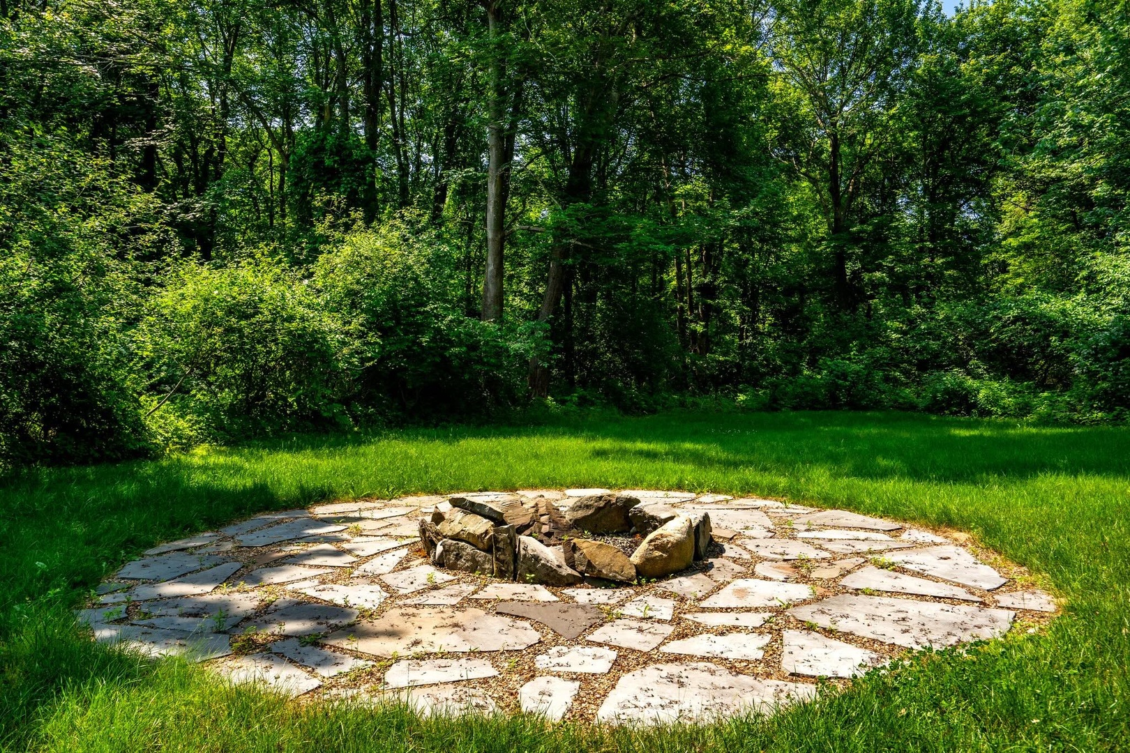 The sunny back yard offers ample space for relaxation