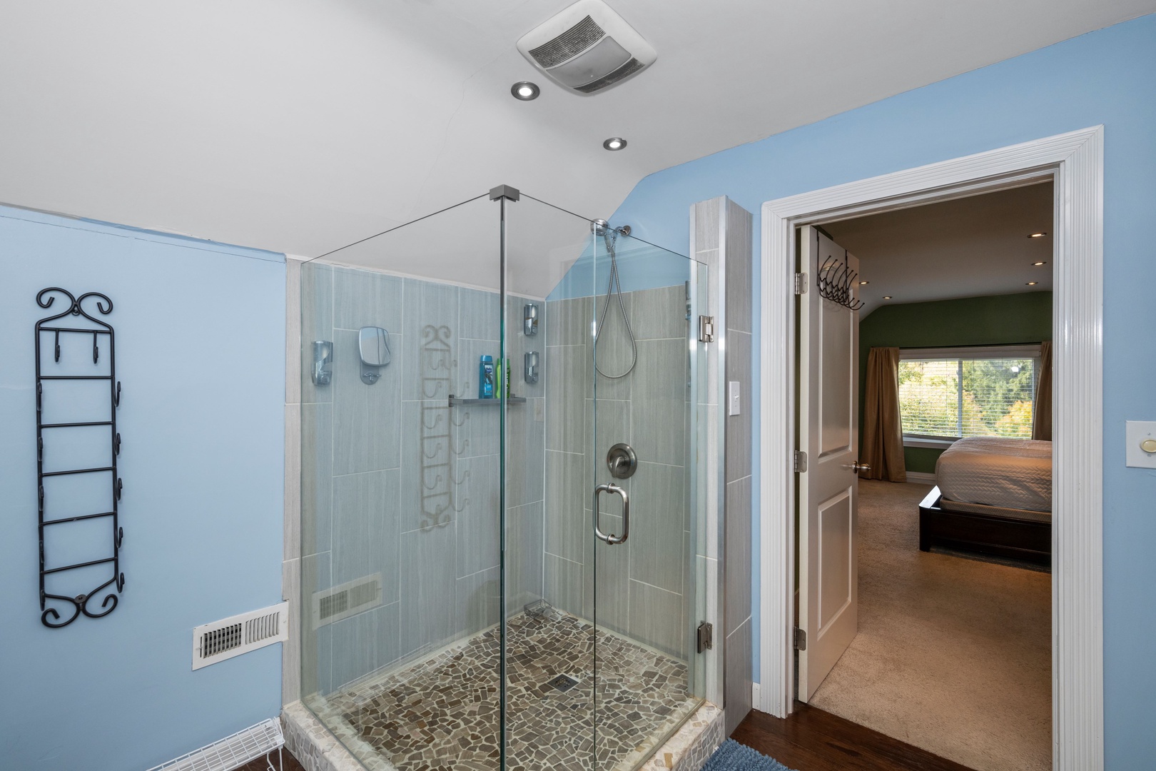 The third-floor en suite offers a double vanity & large, spa-like glass shower
