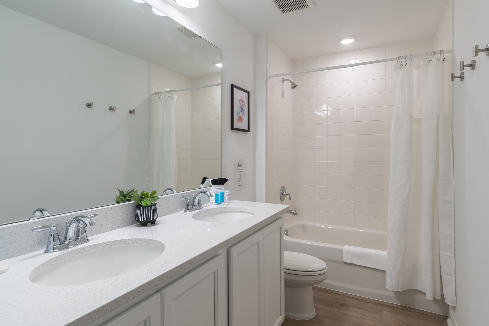 The 2nd floor shared bathroom includes a double vanity & shower/tub combo