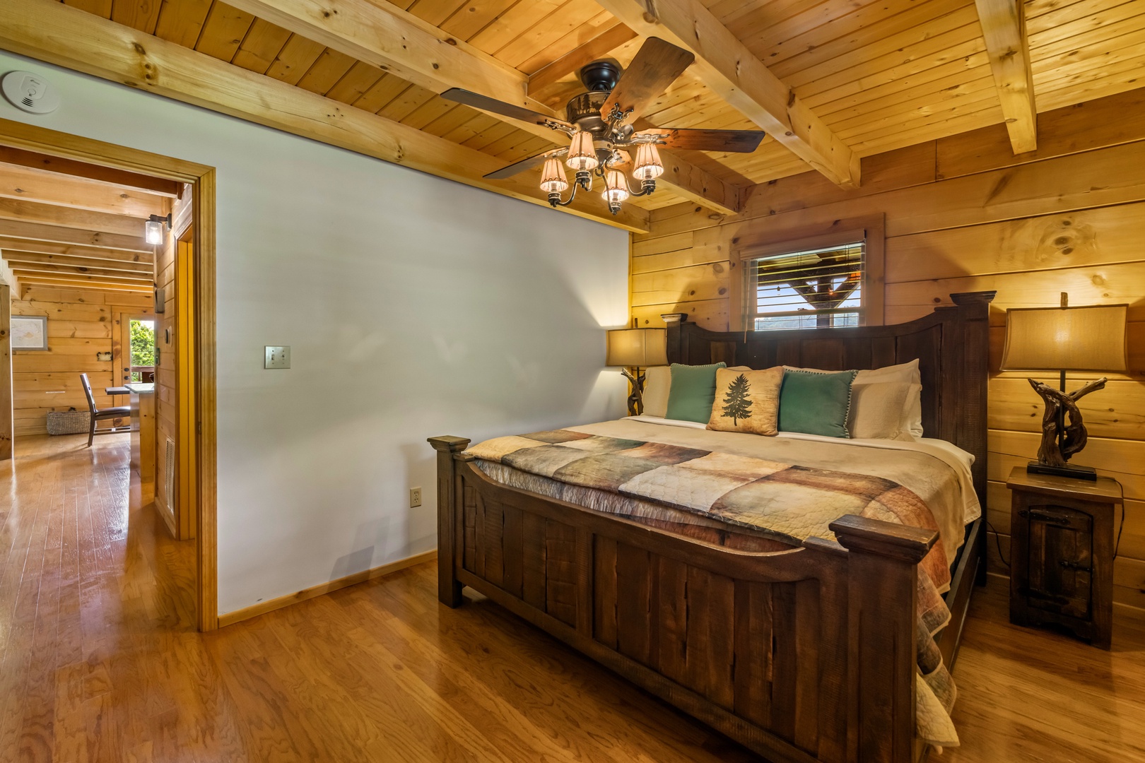 The first of two main-level bedrooms boasts a regal king-sized bed