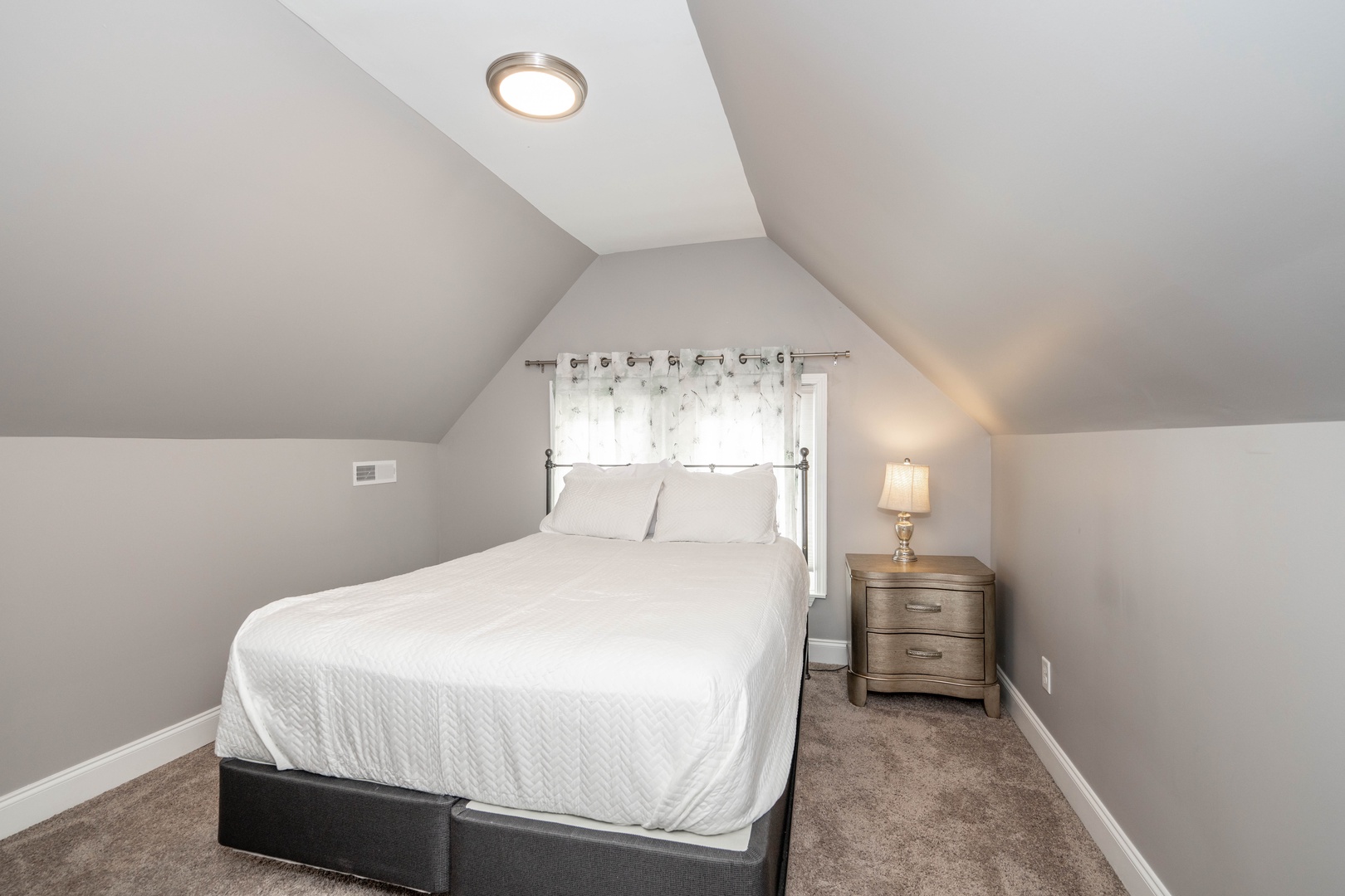 The 1st of 2 bedrooms on the 3rd floor includes a queen-sized bed