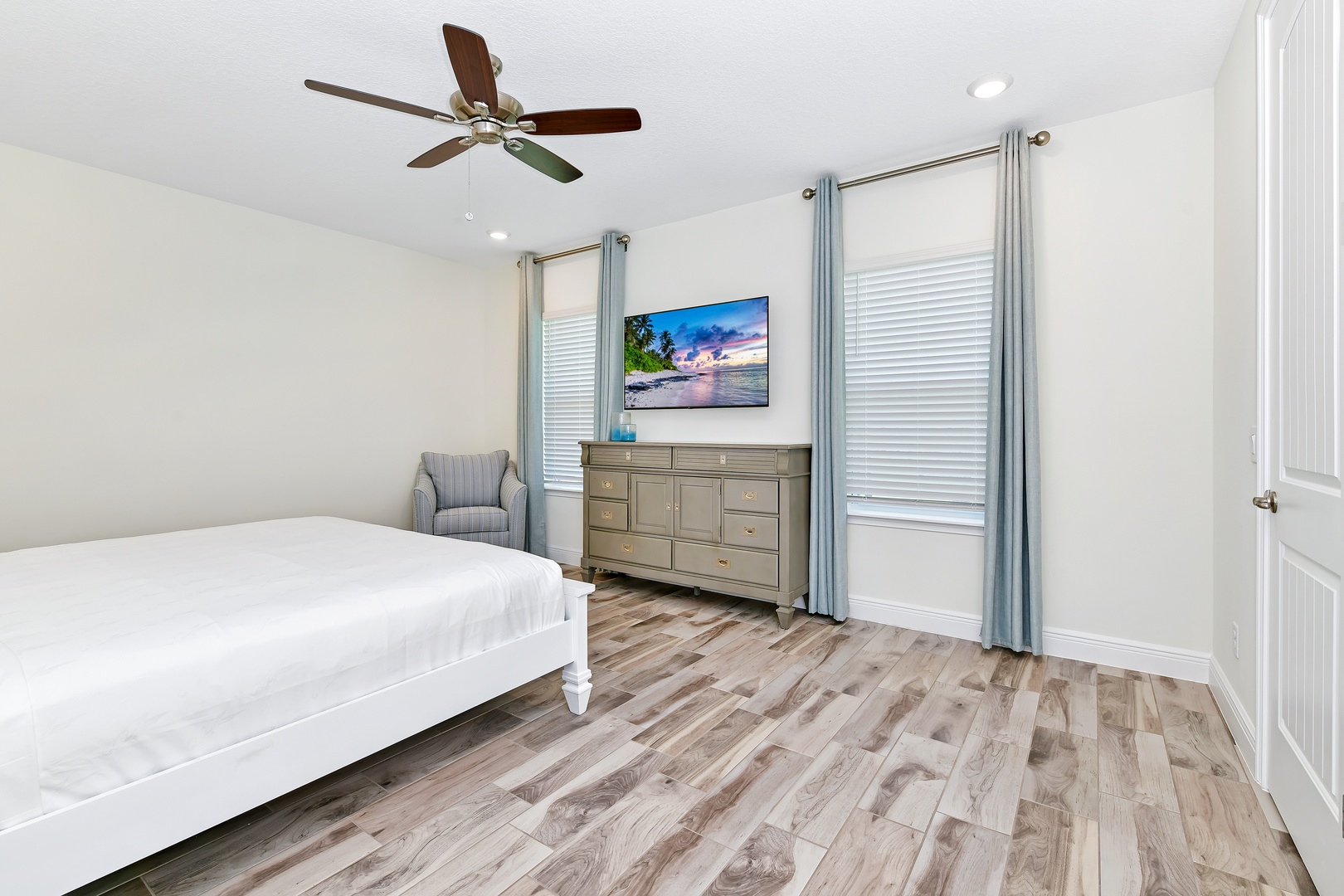 2nd Floor Master featuring a cozy king bed, ceiling fan and private ensuite