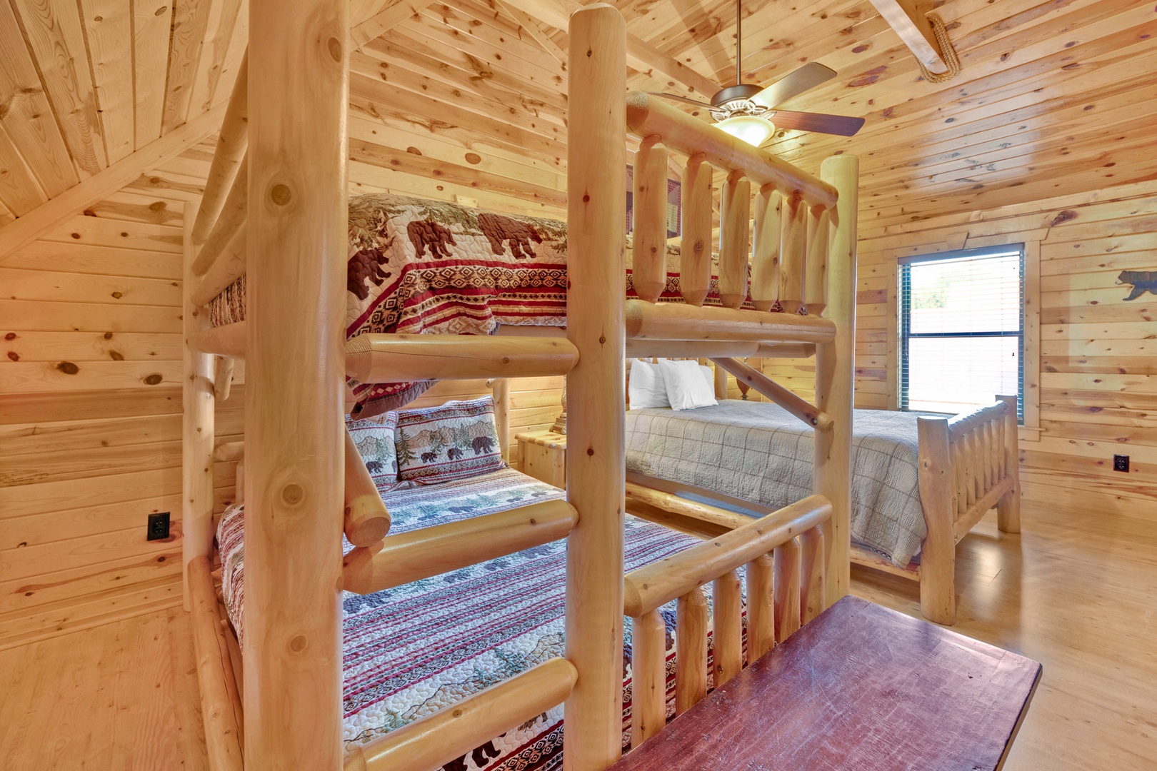 The second-floor bunk room offers a Smart TV, 1 queen bed & queen-over-queen bunks