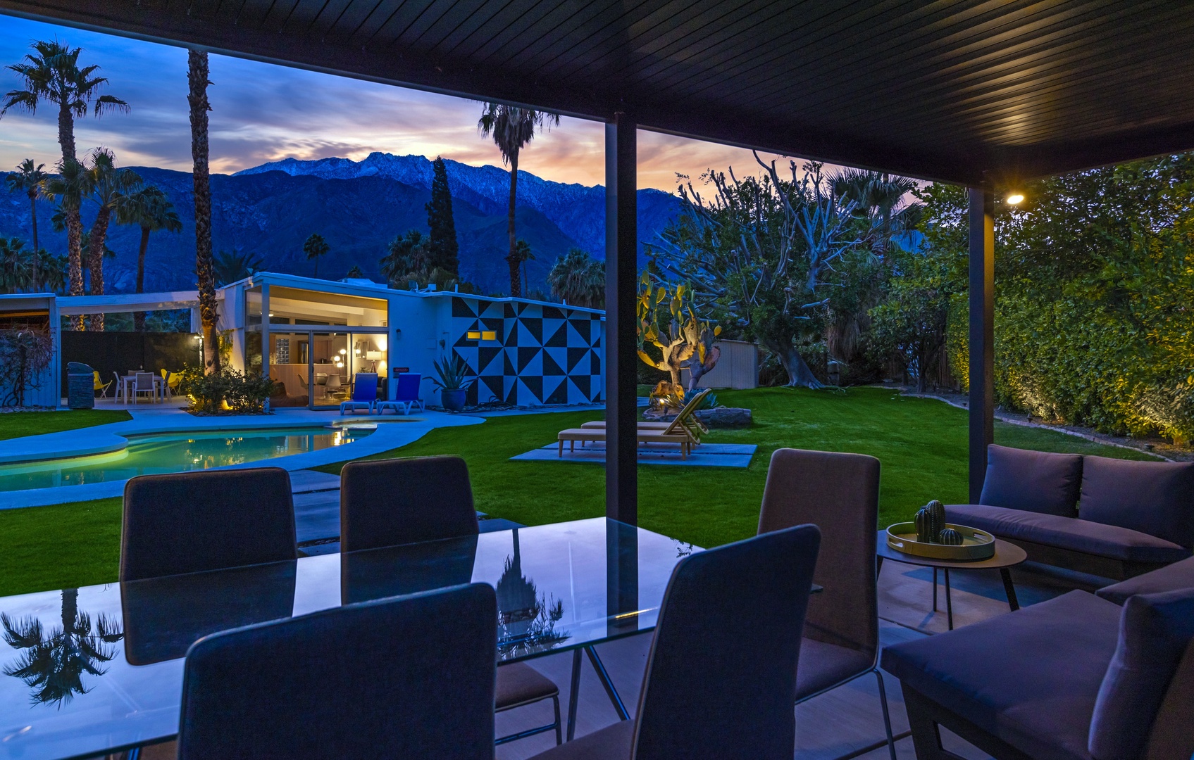 Outdoor dining by the pool with gas BBQ grill