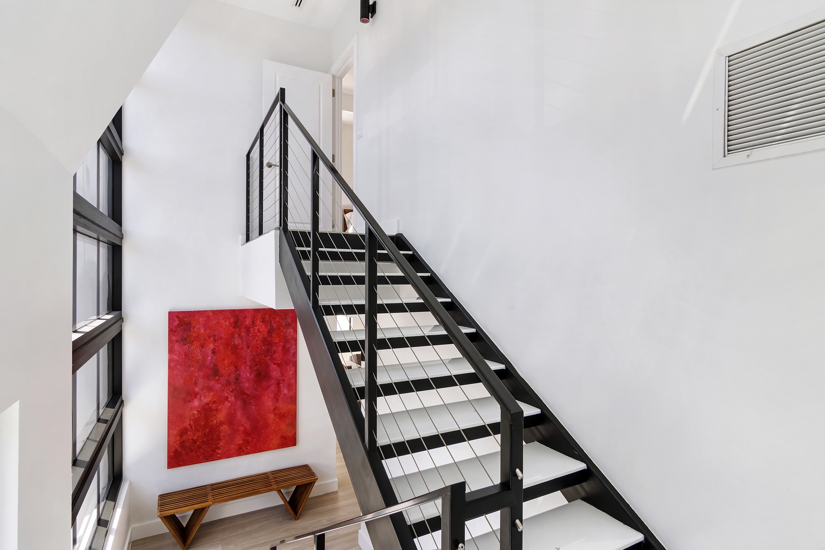 Natural light fills the Instagrammable staircase, leading to the 3rd floor