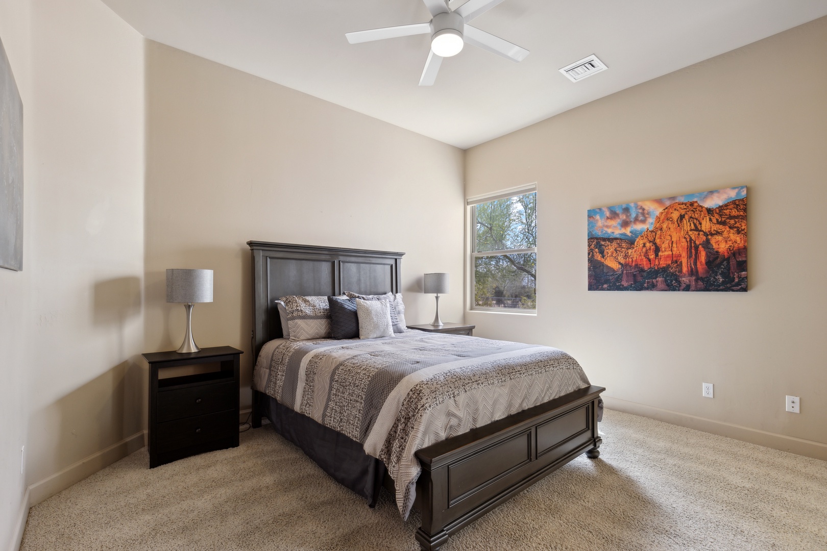 This spacious bedroom offers a queen bed