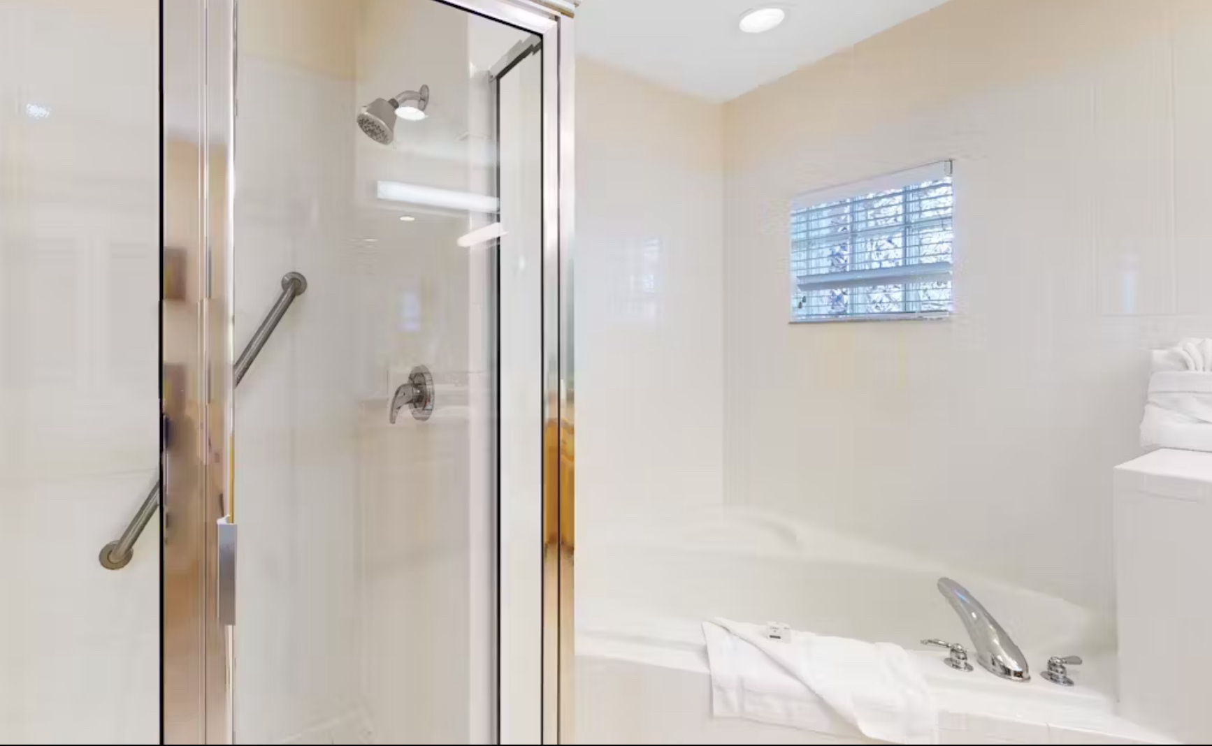 A double vanity, shower, & tub await in the ensuite bath