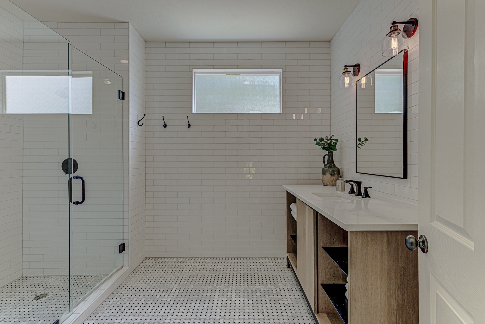 A full bath with single vanity & glass shower is available off the loft