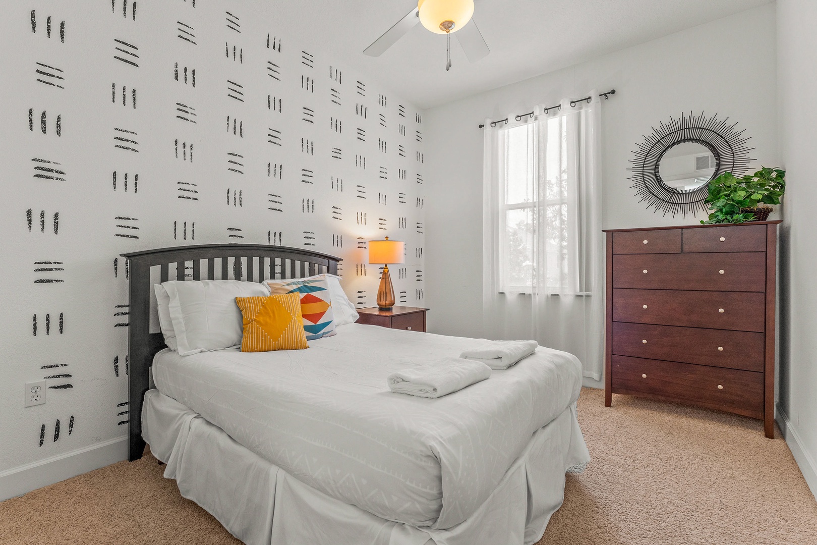 Inviting queen bedroom featuring a ceiling fan