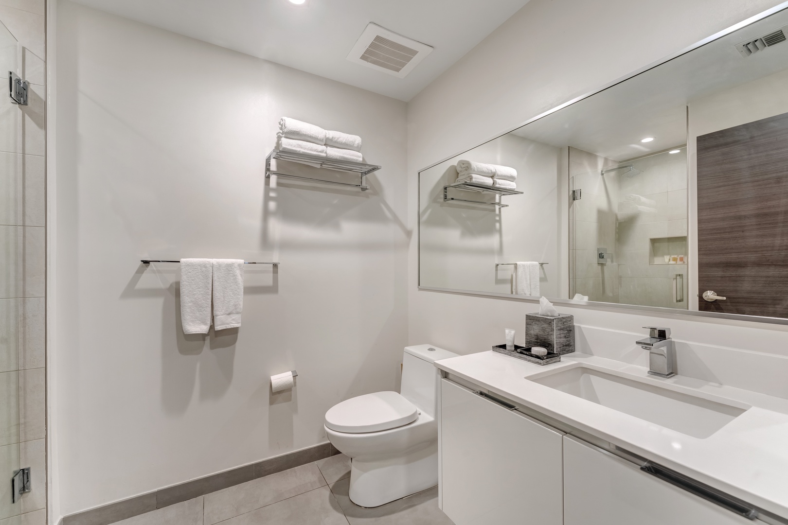 The full bathroom offers a single vanity & spa-like glass shower