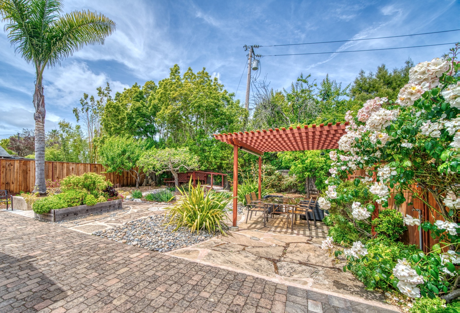 Lounge the day away or enjoy a stroll in the tranquil backyard oasis