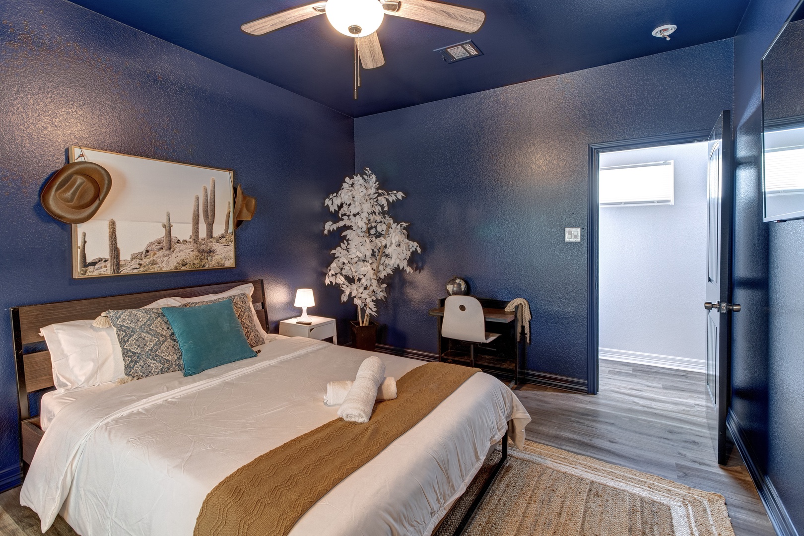 The second bedroom retreat features a plush queen bed & Smart TV