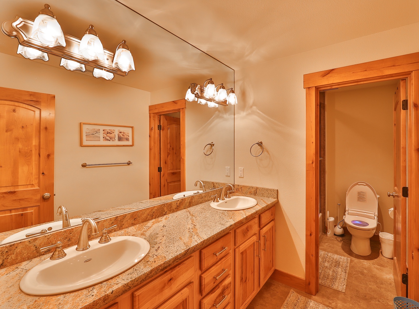 Full bathroom with dual vanity, and shower/tub combo