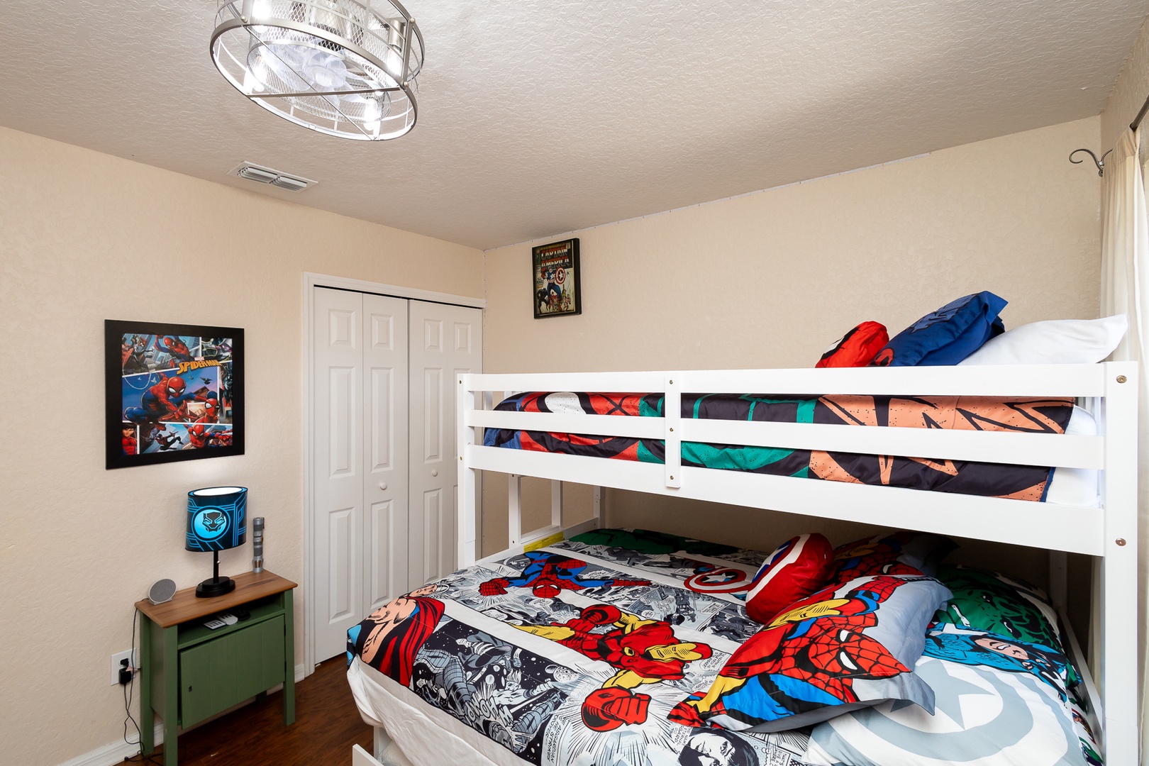 Superheroes can slumber on this bedroom’s twin/queen bunks & twin trundle