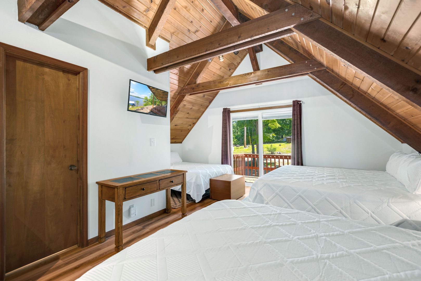 The airy loft boasts a trio of plush beds: 2 queens, 1 king & Smart TV