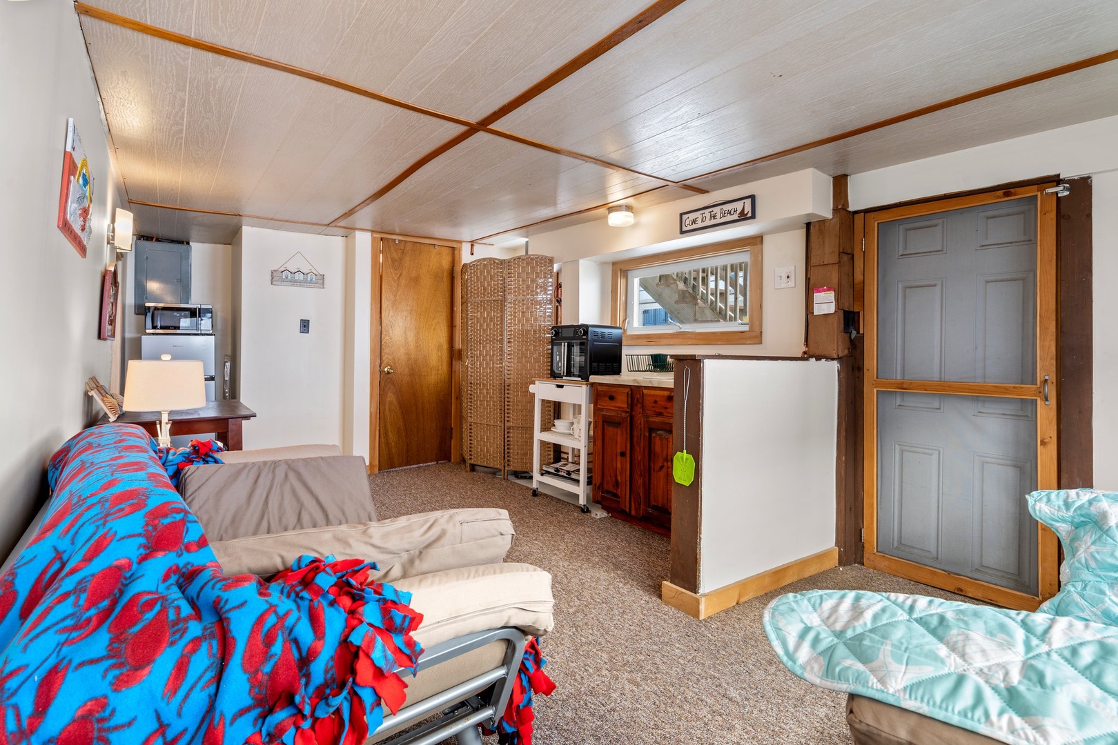 Downstairs living area with ample seating and full bathroom