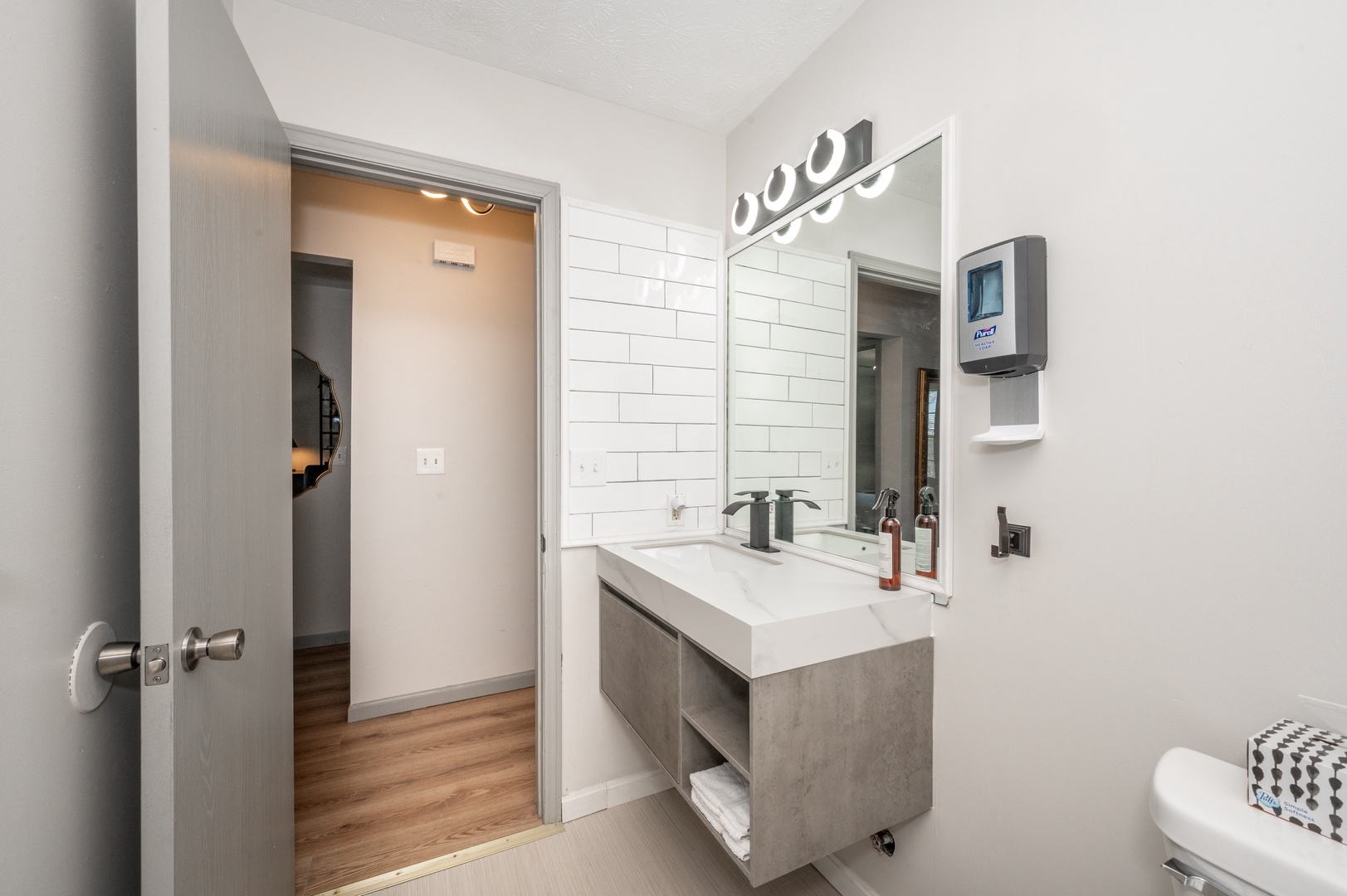 The full bathroom in Apartment 1 features a single vanity & shower/tub combo