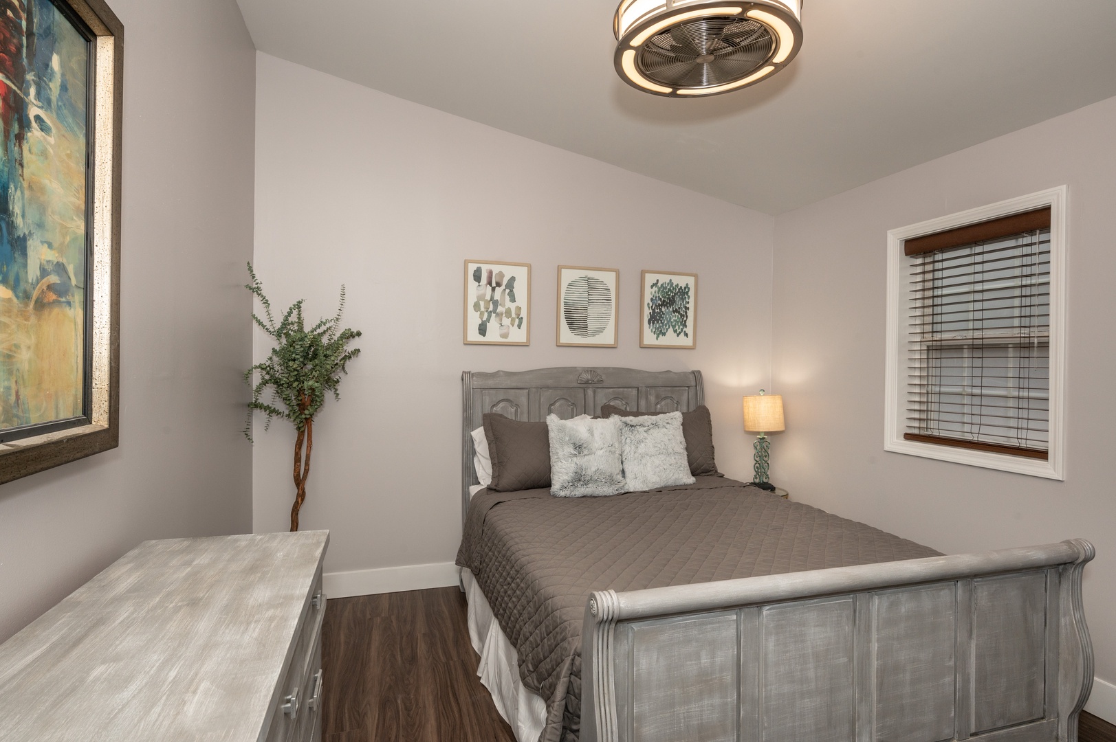 Apt 2 – The tranquil queen bedroom offers a ceiling fan & dresser