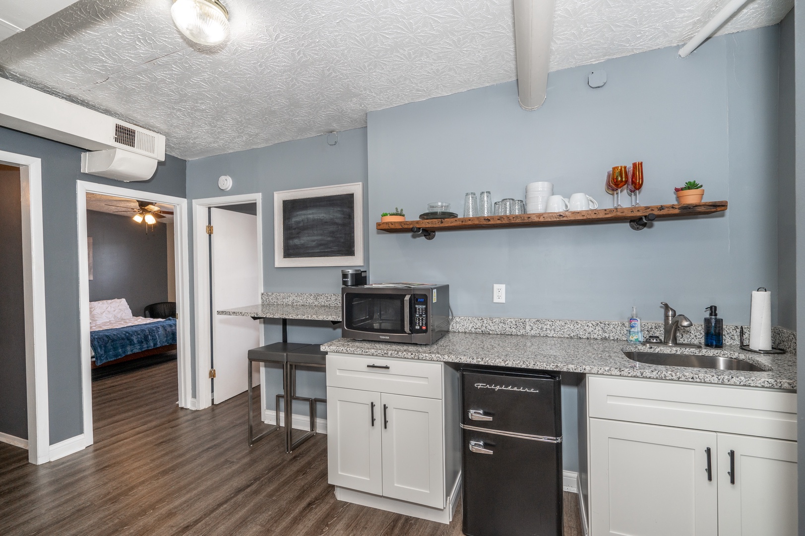 The streamlined kitchenette is well-equipped for your visit
