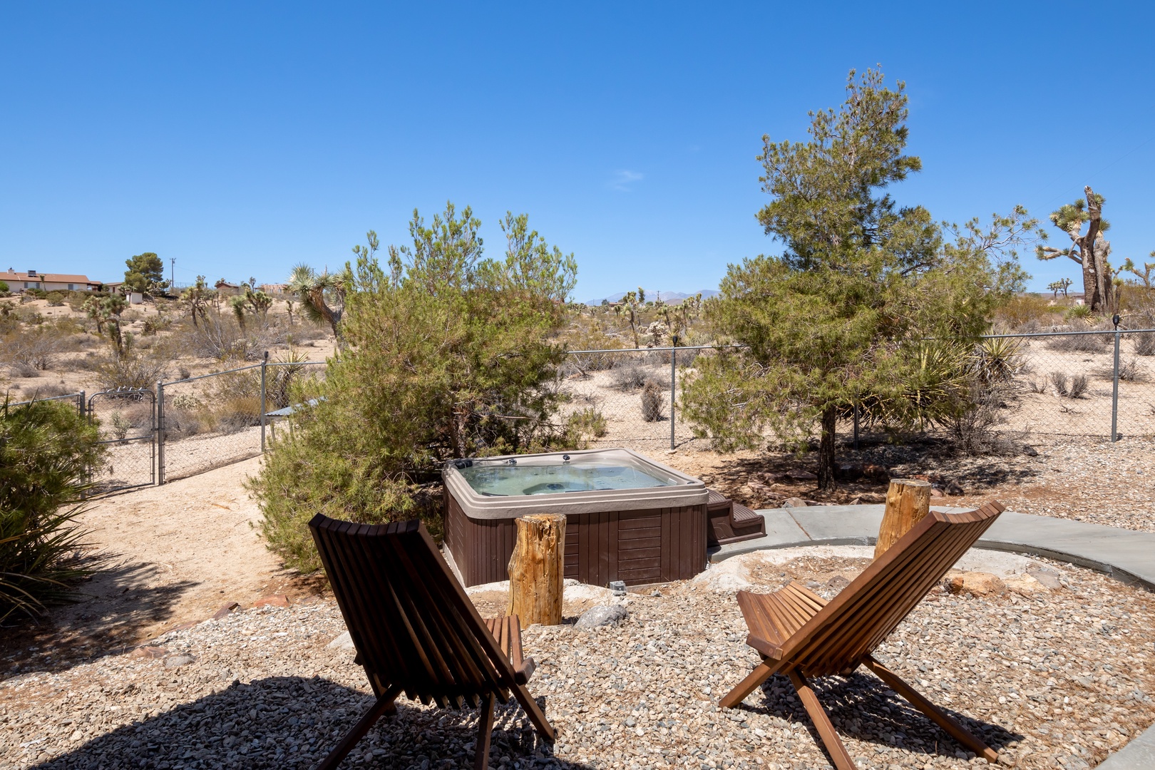 Back yard with out door seating, corn hole, fire pit, and private hot tub