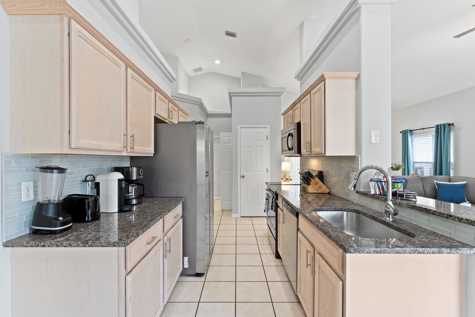 The airy kitchen offers ample space & all the comforts of home