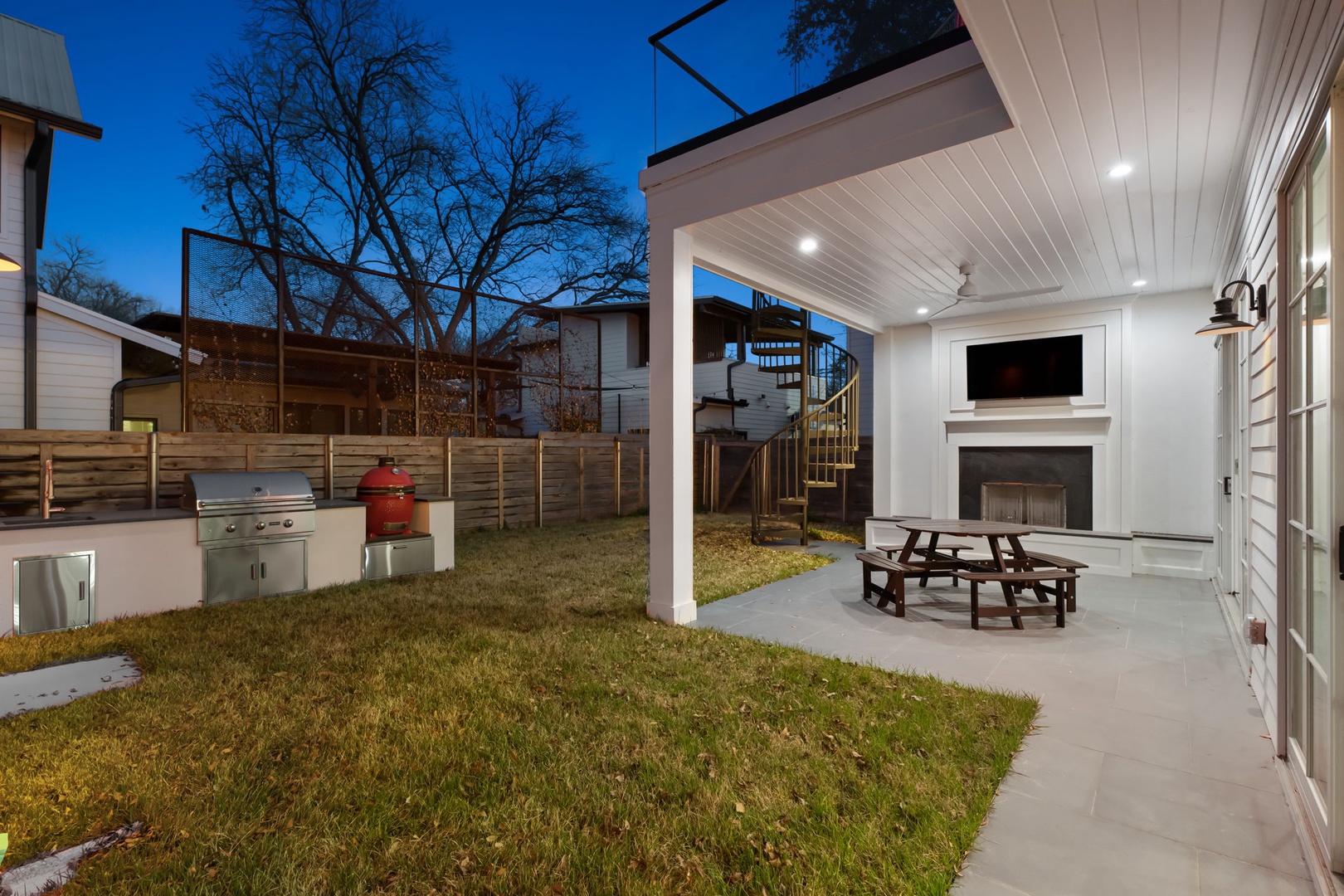 Back yard with outdoor dining area and grill