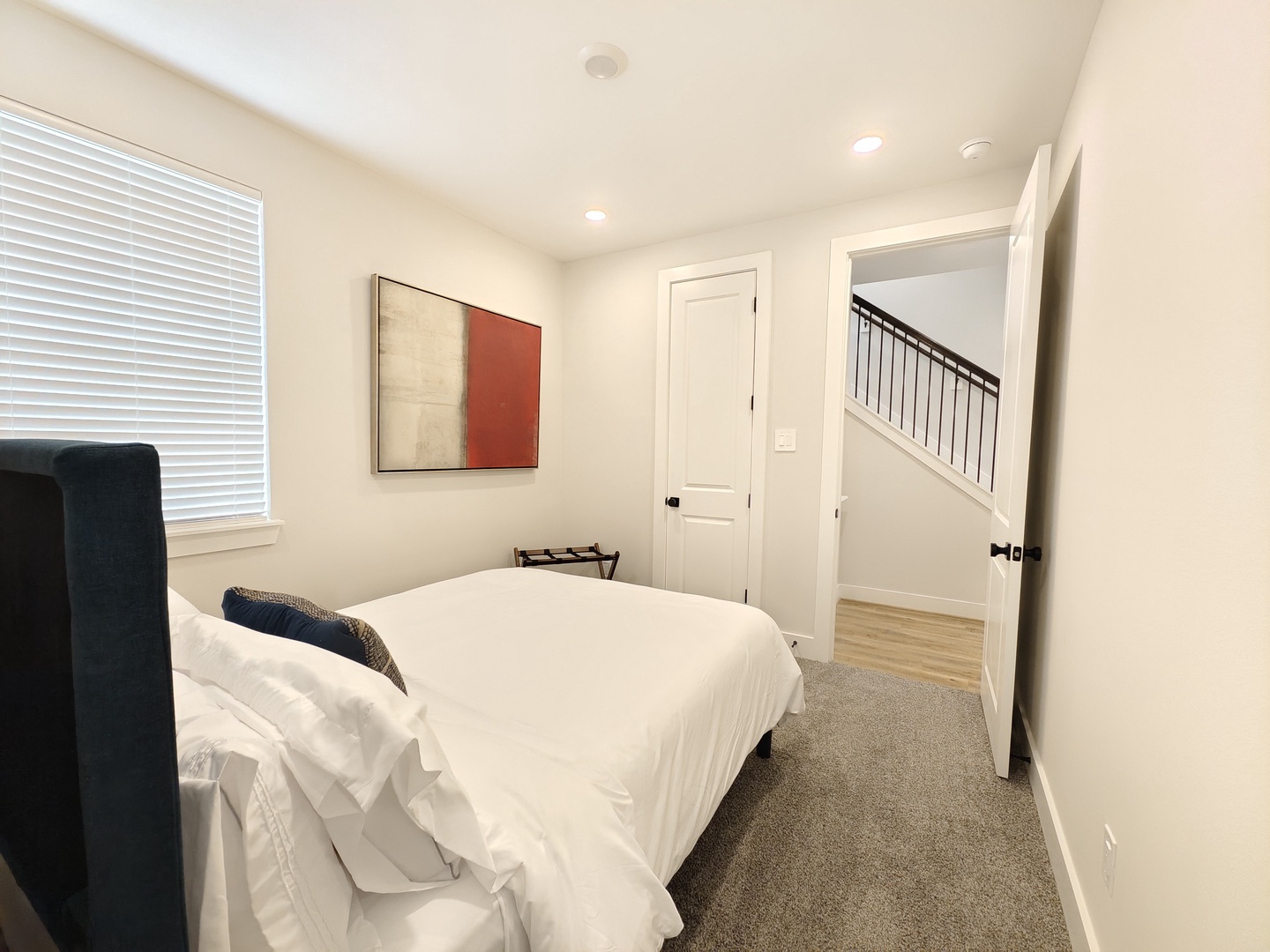 The 1st-floor suite features a plush queen bed & private ensuite