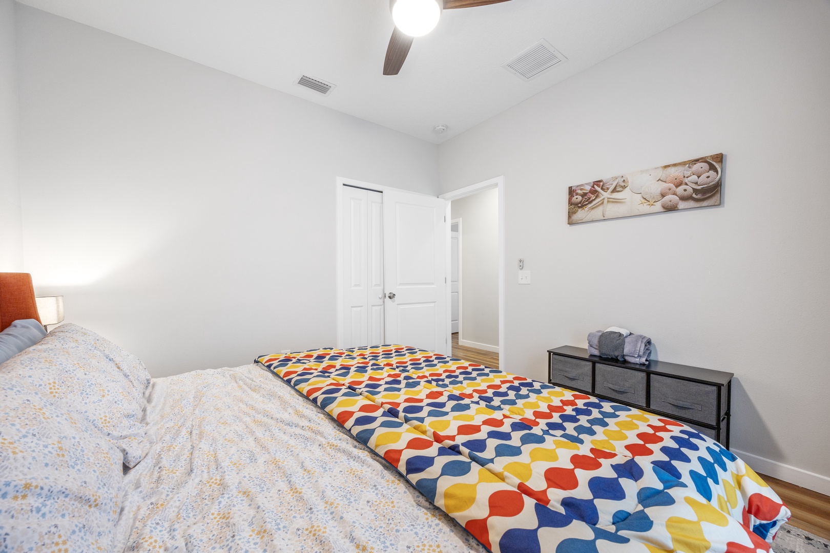 A plush king-sized bed is included in this bright& cozy bedroom