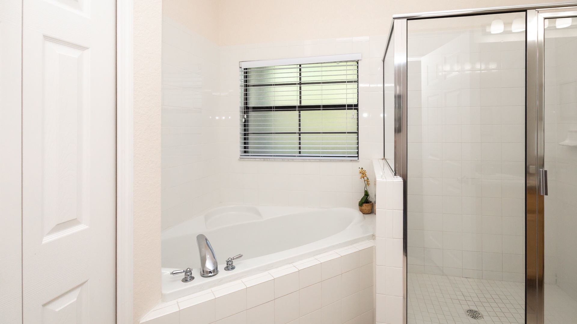 The king en suite offers a dual vanity, glass shower, & luxurious soaking tub