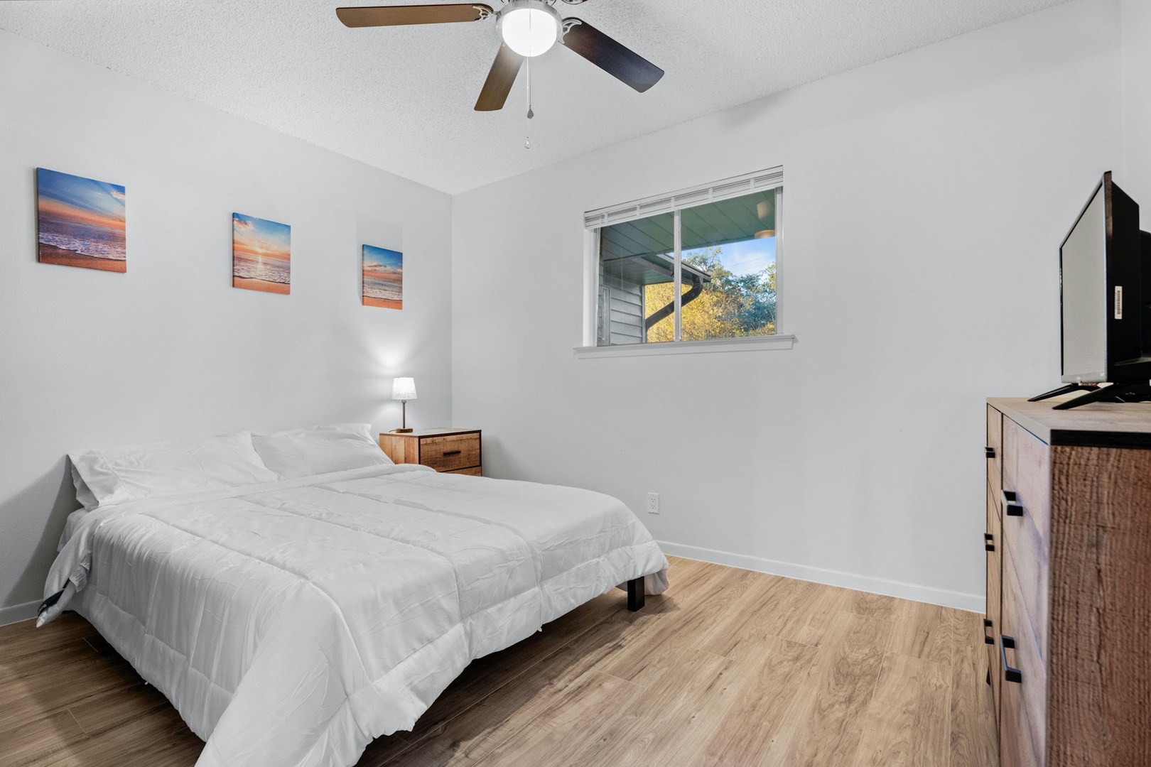 The spacious 2nd bedroom includes a queen bed & Smart TV