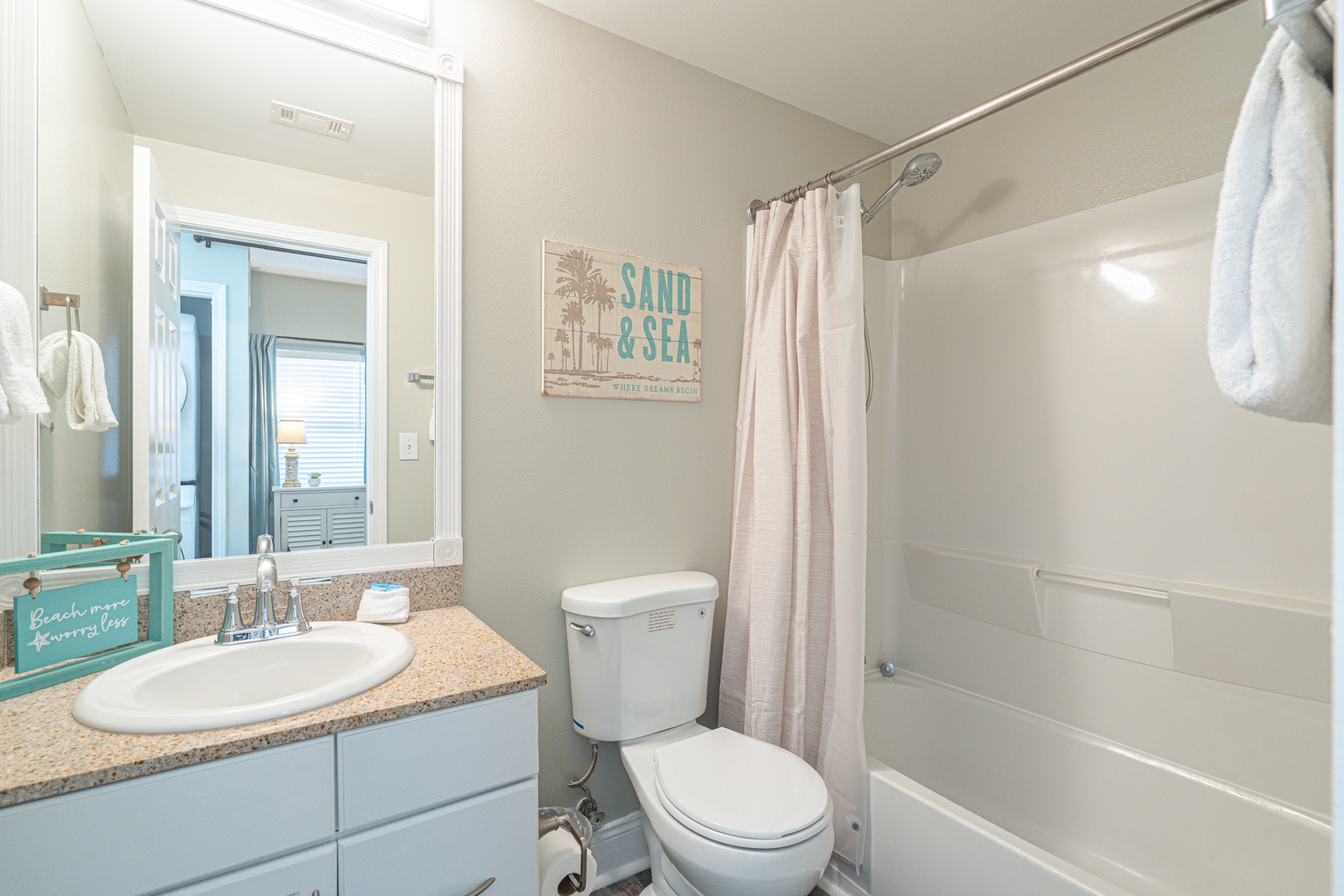 This full bathroom includes a single vanity & shower/tub combo
