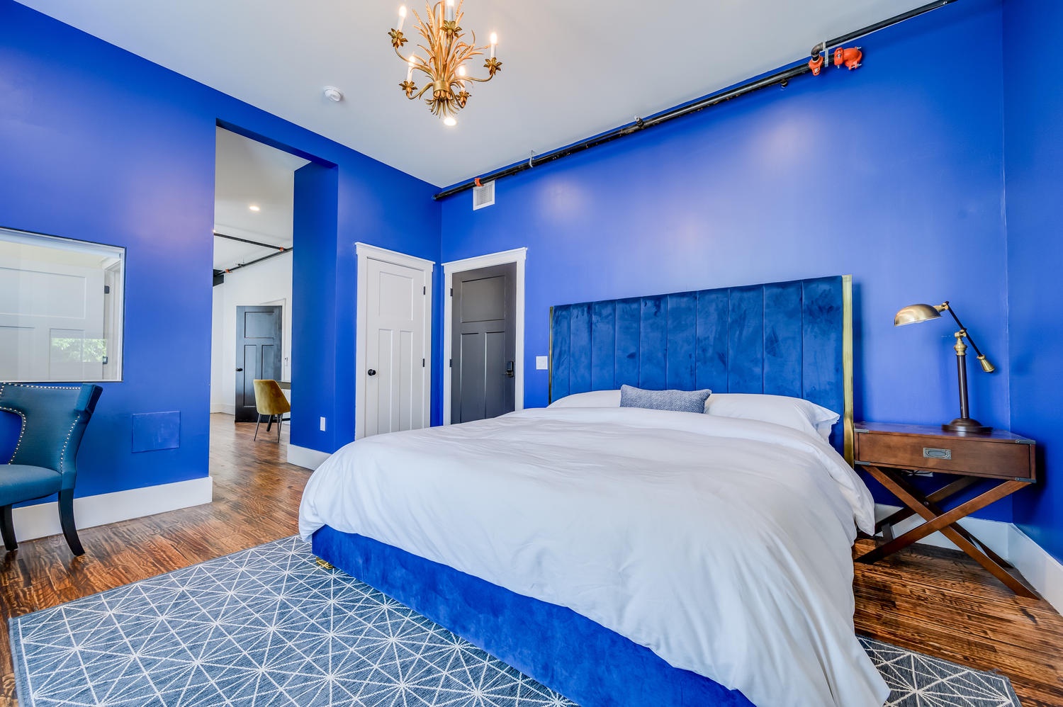 Suite 102 – The 1st Floor Blue Kusama Suite offers King and Queen Casper Beds, Smart TV, Patio Access, and private Bathroom