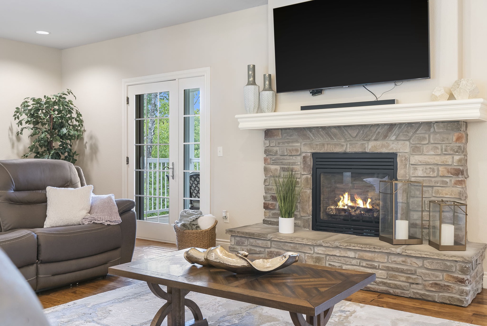 Living room with ample seating, fireplace, Smart TV, and deck access