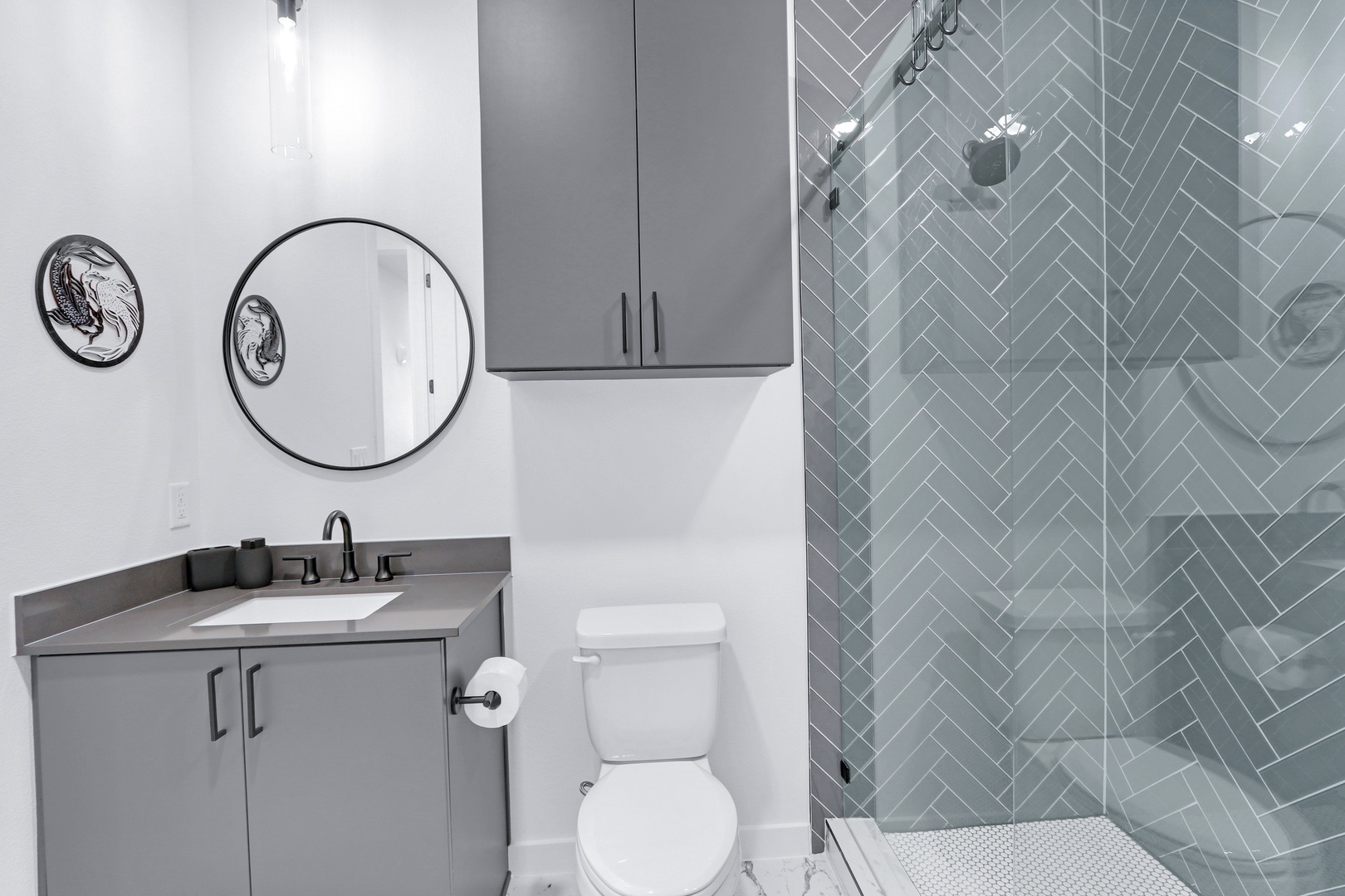 The sophisticated full bath includes a single vanity & glass shower