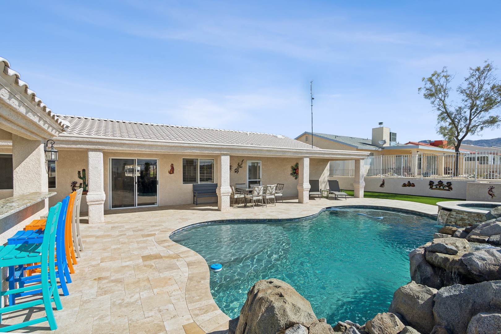 A mountain-view oasis, with a waterfall pool, hot tub, & outdoor kitchen!