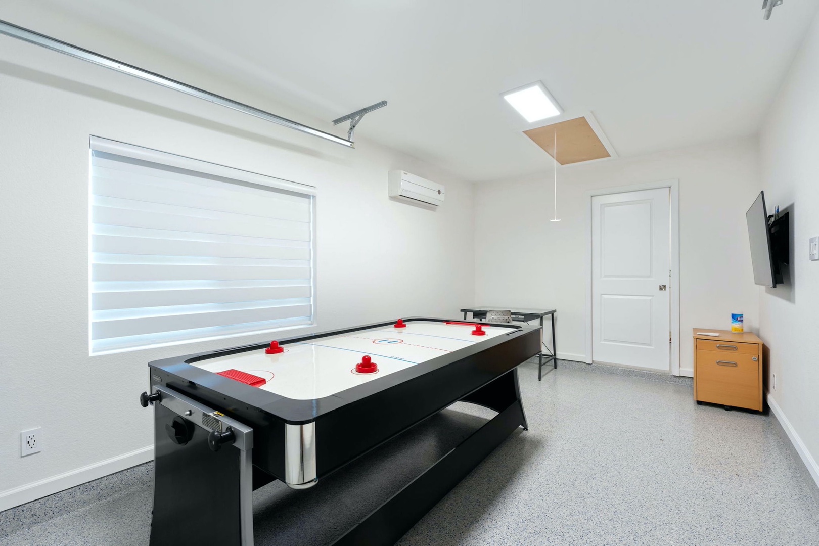 Get competitive with a round of air hockey in the garage game room