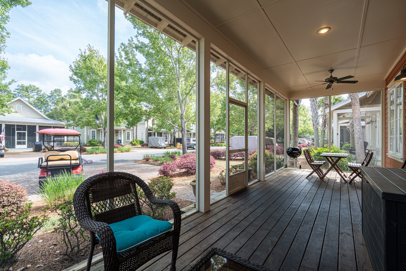 Screened porch with seating and grill